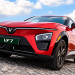 Red VinFast VF 7 electric SUV illustrating fuel savings from EV ownership.