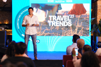 Neel Ghose presenting Skyscanner Travel Trends 2027 on stage